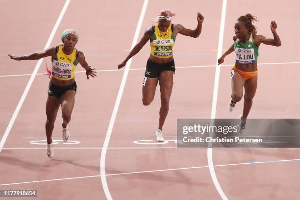 Shelly-Ann Fraser-Pryce of Jamaica crosses the finish line to win the Women's 100 Metres final ahead of Elaine Thompson of Jamaica and Marie-Josée Ta...