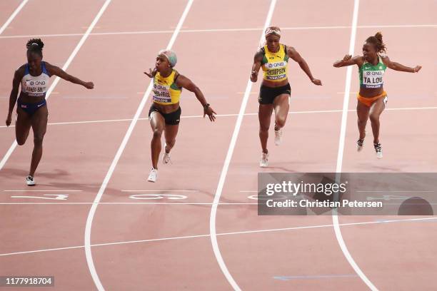 Shelly-Ann Fraser-Pryce of Jamaica crosses the finish line to win the Women's 100 Metres final ahead of Dina Asher-Smith of Great Britain, Elaine...