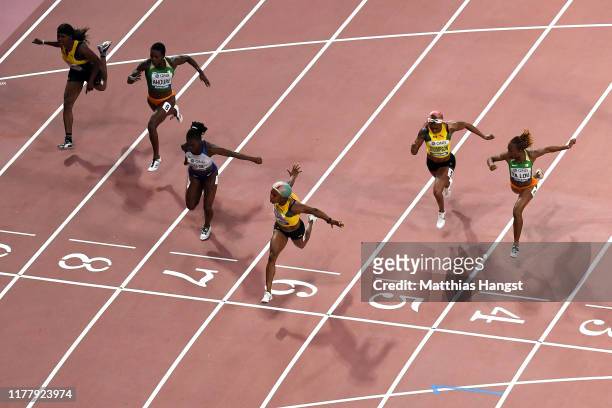 Shelly-Ann Fraser-Pryce of Jamaica crosses the finish line to win the Women's 100 Metres final ahead of Dina Asher-Smith of Great Britain, Elaine...