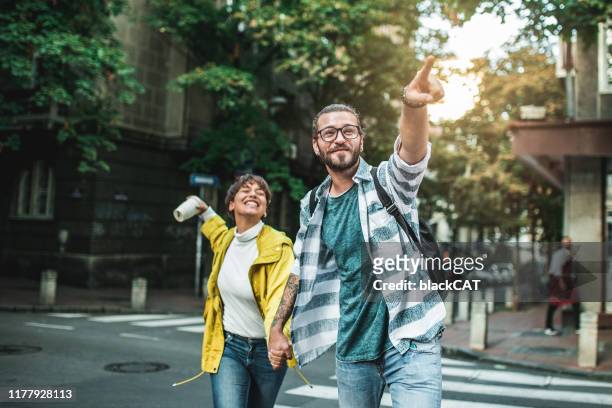 young couple enjoying in a free day outside - city breaks stock pictures, royalty-free photos & images