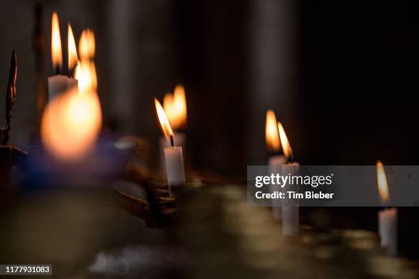 candles burning in a catholic church - lucky ghost stock pictures, royalty-free photos & images