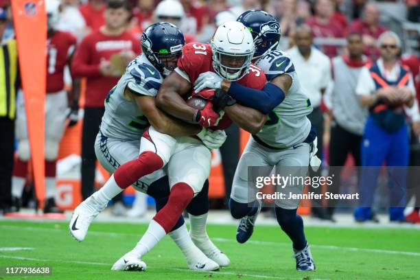 Running back David Johnson of the Arizona Cardinals carries the ball against linebacker Mychal Kendricks and strong safety Bradley McDougald of the...