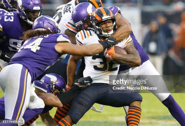 David Montgomery of the Chicago Bears is tackled by Anthony Barr and Eric Kendricks of the Minnesota Vikings during the second half at Soldier Field...