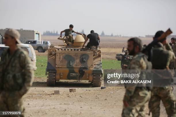 Turkey-backed Syrian fighters take over areas on the road between Tal Abyad and Kobane on October 24 as Kurdish forces in northeastern Syria left...