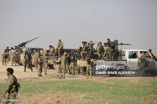 Turkey-backed Syrian fighters take over areas on the road between Tal Abyad and Kobane on October 24 as Kurdish forces in northeastern Syria left...