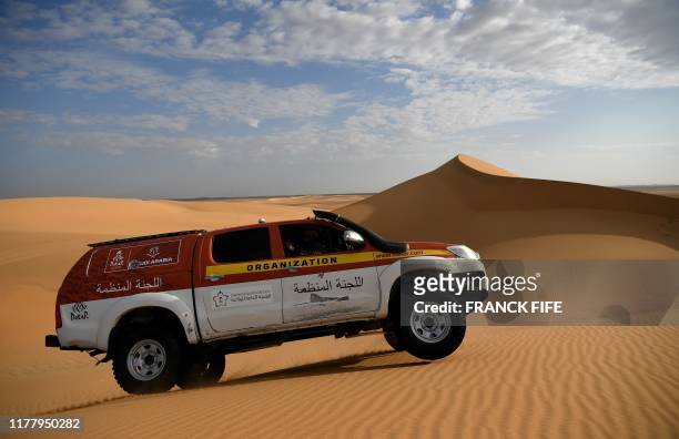 Dakar rally manager of the road book Pablo Eli and sports coordinator Edo Mossi drive on October 18, 2019 in Saudi Arabia during the recce for the...