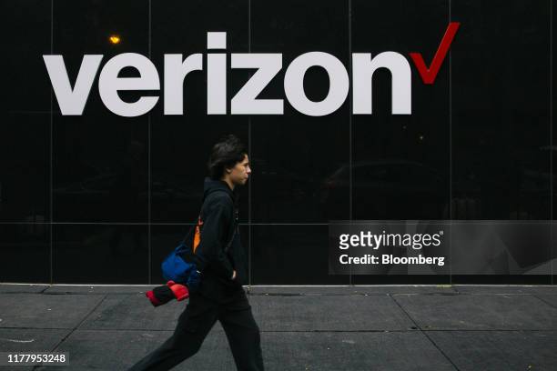 Pedestrian passes in front of Verizon Communications Inc. Signage outside a store in Chicago, Illinois, U.S., on Tuesday, Oct. 22, 2019. Verizon...