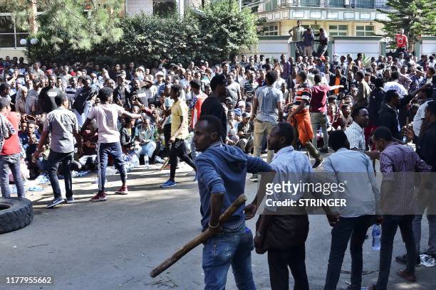 Supporters of Jawar Mohammed, a member of the Oromo ethnic group who has been a public critic of Abiy, gather outside his home in the Ethiopian...