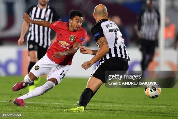 Manchester United's English midfielder Jesse Lingard vies with FK Partizan's Serbian defender Nemanja Miletic during the UEFA Europa league group L...
