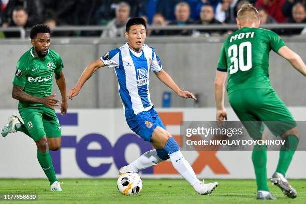 Espanyol's Chinese forward Wu Lei fights for the ball with Ludogorets Razgrad's Senegalese midfielder Stephane Badji and Ludogorets Razgrad's...