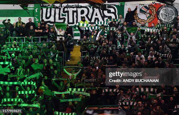 Celtic fans wave their scarves ahead of the UEFA Europa League group E football match between Celtic and Lazio at Celtic Park stadium in Glasgow,...