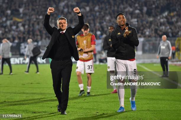 Manchester United's Norwegian manager Ole Gunnar Solskjaer and Manchester United's French striker Anthony Martial gesture at the final whistle during...