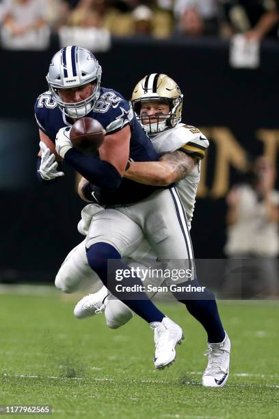 Jason Witten of the Dallas Cowboys stripped of the ball by A.J. Klein of the New Orleans Saints during the first half of a NFL game at the Mercedes...
