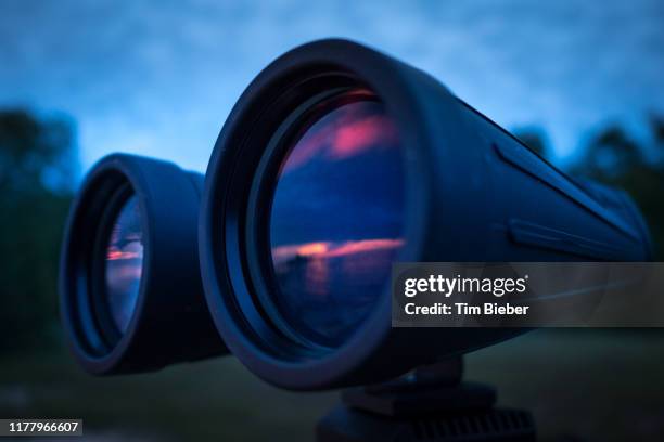 sunset reflected in binoculars. - tripod isolated stock pictures, royalty-free photos & images