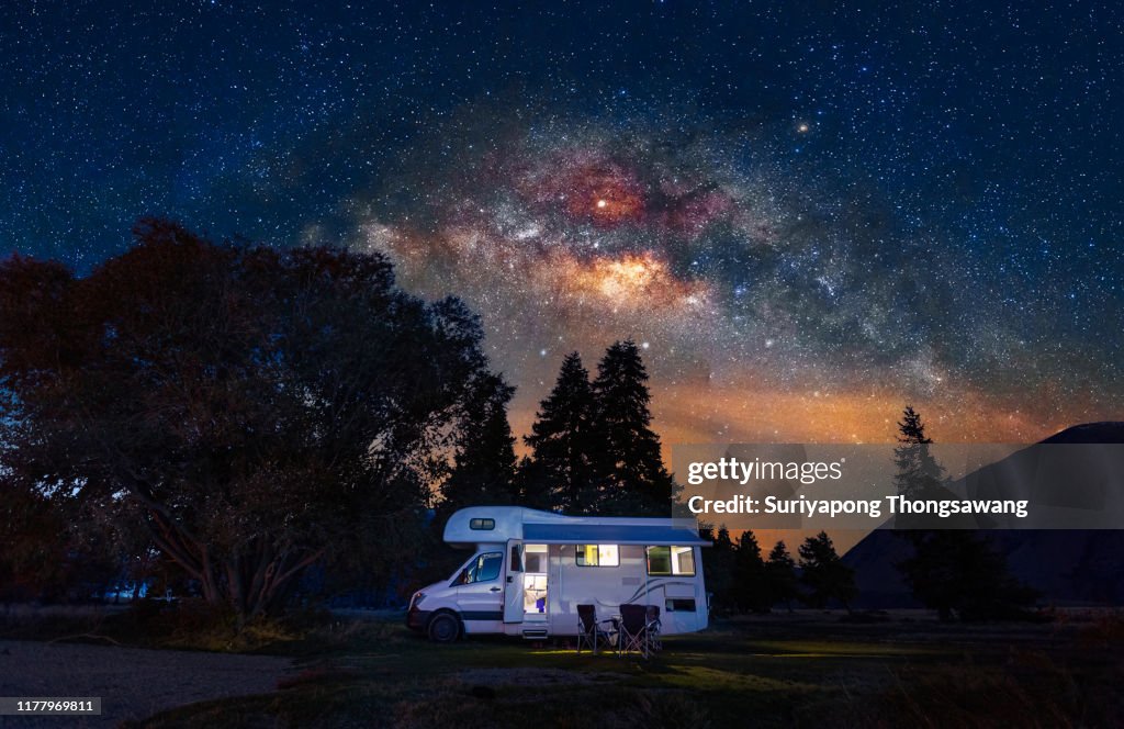 Motorhome at free camp site with milky way sky in New Zealand.