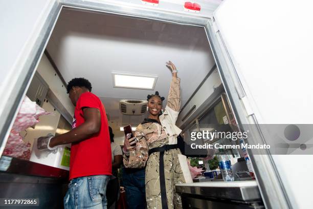 Nafessa Williams is seen serving from a food truck during the "Black & Blue" cast members' visit to Morehouse College on October 24, 2019 in Atlanta,...