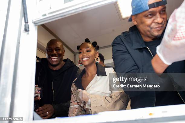 Tyrese Gibson, Nafessa Williams, and Deon Taylor are seen serving from a food truck during the "Black & Blue" cast members' visit to Morehouse...