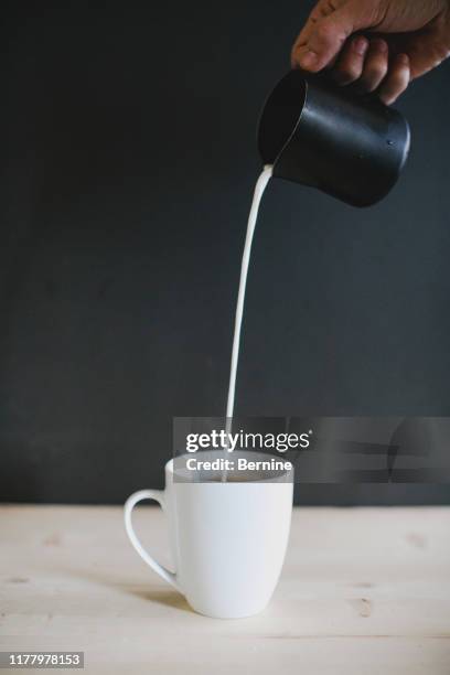 stream of steamed milk being poured into latte - barista coffee milk stock pictures, royalty-free photos & images