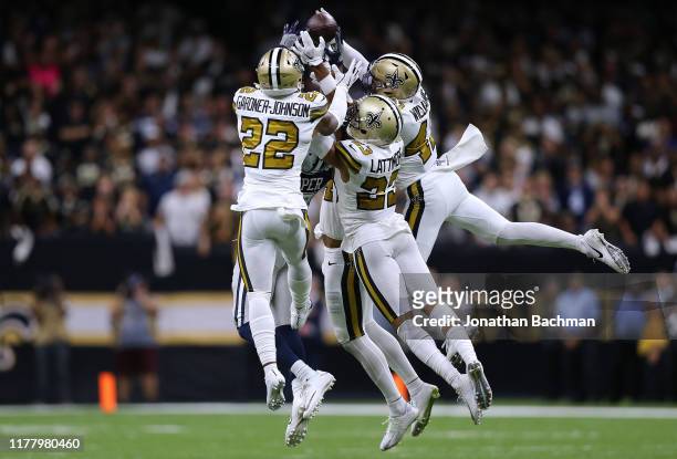 Chauncey Gardner-Johnson of the New Orleans Saints, Marcus Williams and Marshon Lattimore breaks up a pass intended for Amari Cooper of the Dallas...