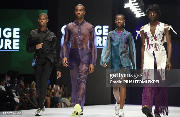 Models wears Orange Culture creations during the yearly Lagos Fashion Week in Lagos, on October 24, 2019. - Lagos Fashion Week is a fashion platform...