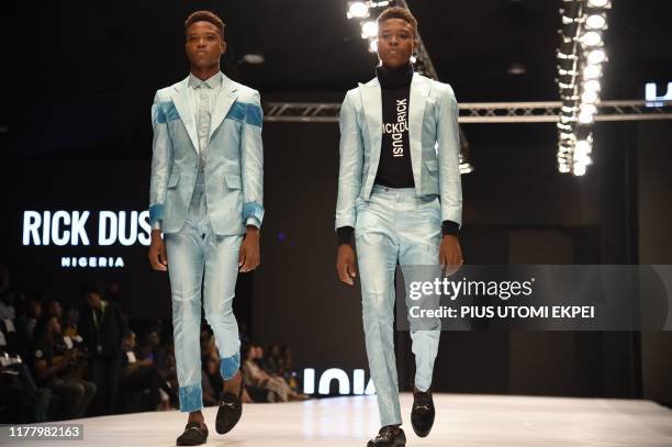 Models wear Rick Dusi creations during the yearly Lagos Fashion Week in Lagos, on October 24, 2019. - Lagos Fashion Week is a fashion platform...