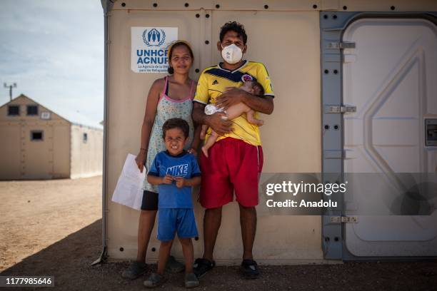 Andres, a Venezuelan poses for a photo with his family, after a long tuberculosis treatment, on their last day at the UNHCR camp in Maicao, La...