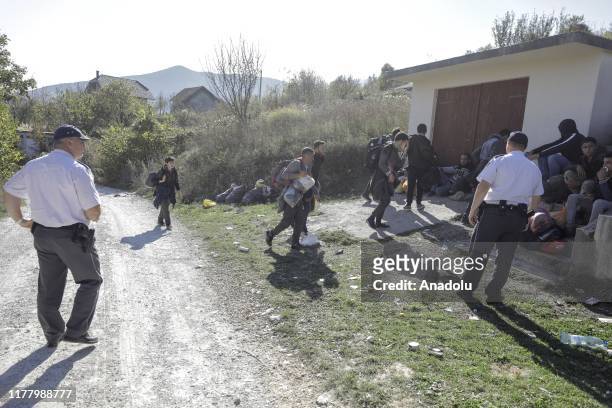 Border police speak with migrants, who try to cross the natural borders into Croatia, during a border patrol of Bosnia and Herzegovina's Border...