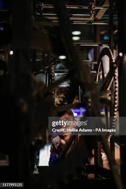 Assistant Curator of Science Matthew Howles takes a look inside the Wells Cathedral Clock at the Clockmakers' Museum, part of the Science Museum in...
