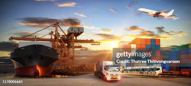 container truck in ship port for business logistics and transportation of container cargo ship and cargo plane with working crane bridge in shipyard at sunrise, logistic import export and transport industry background - port airport stock pictures, royalty-free photos & images