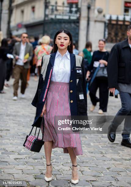 Guest is seen wearing red skirt, blazer with patches outside Thom Browne during Paris Fashion Week Womenswear Spring Summer 2020 on September 29,...