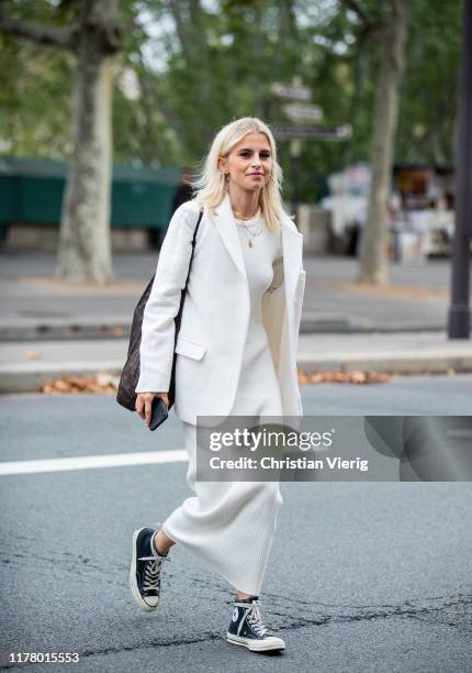 Caroline Caro Daur seen wearing white dress, blazer during Paris Fashion Week Womenswear Spring Summer 2020 on September 29, 2019 in Paris, France.