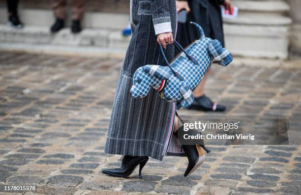 Mademoiselle Yulia seen wearing bag that looks like a dog, grey striped dress outside Thom Browne during Paris Fashion Week Womenswear Spring Summer...