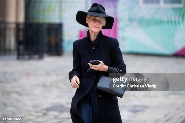 Kate Lanphear is seen wearing floppy hat outside Thom Browne during Paris Fashion Week Womenswear Spring Summer 2020 on September 29, 2019 in Paris,...