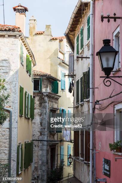 looking down the narrow streets of rovinj - rovinj stock pictures, royalty-free photos & images