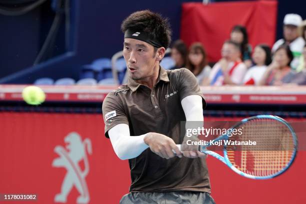 Yuichi Sugita of Japan hits a return shot against Marin Cilic of Croatia on day one of the Rakuten Open at the Ariake Coliseum on September 30, 2019...