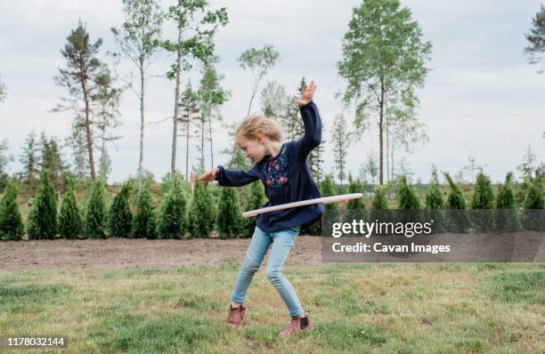 young girl in her garden playing with a hula hoop - hooping stock pictures, royalty-free photos & images