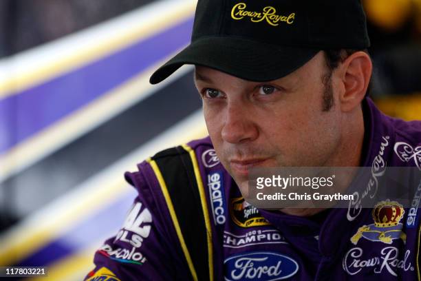 Matt Kenseth, driver of the Affliction Clothing Ford, looks on in the gagrage during practice for the NASCAR Sprint Cup Series COKE ZERO 400 Powered...
