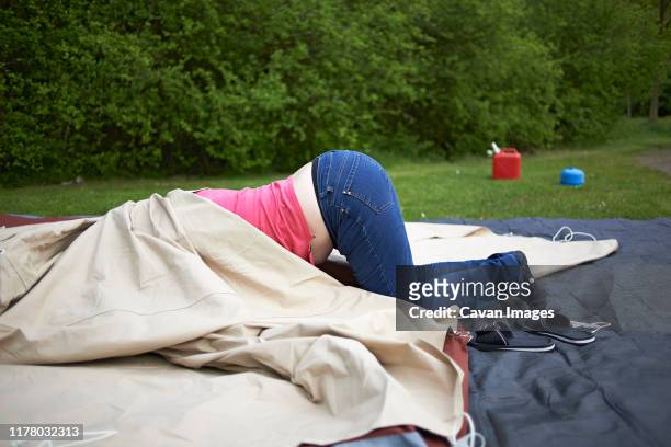 funny shot of a woman covered under tent canvas during set-up - the comedy tent stock pictures, royalty-free photos & images