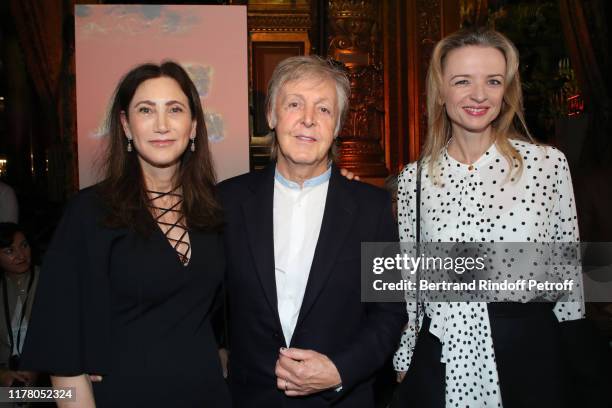 Paul McCartney standing between his wife Nancy Shevell and Louis Vuitton's executive vice president Delphine Arnault attend the Stella McCartney...