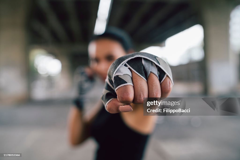 Powerful young woman punching