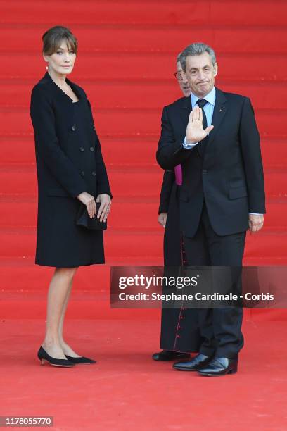 Carla Bruni-Sarkozy and Nicolas Sarkozy arrive to attend a church service for former French President Jacques Chirac at Eglise Saint-Sulpice on...