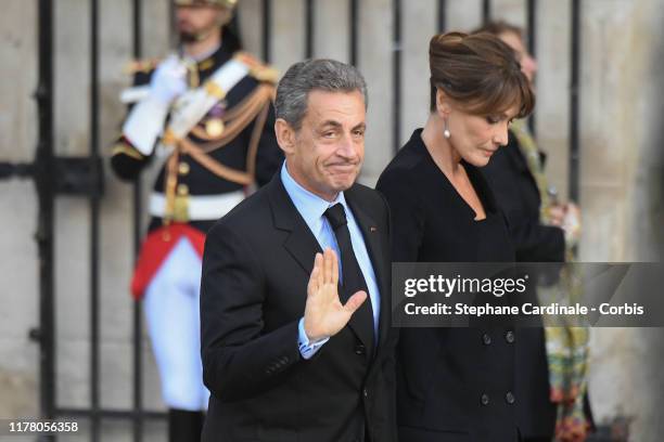 Carla Bruni-Sarkozy and Nicolas Sarkozy arrive to attend a church service for former French President Jacques Chirac at Eglise Saint-Sulpice on...