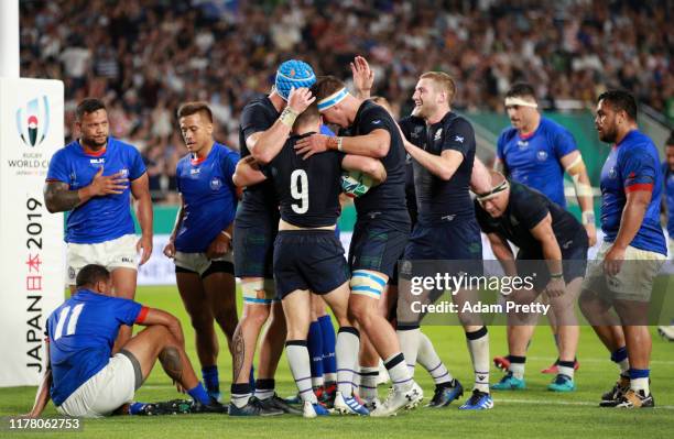 Greig Laidlaw of Scotland celebrates with teammates after scoring his team's second try during the Rugby World Cup 2019 Group A game between Scotland...