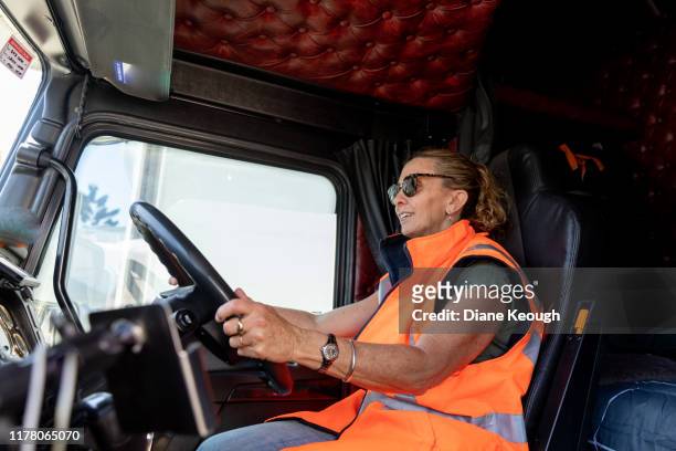 female driving a truck with high visibility vest - 2019 truck stock-fotos und bilder