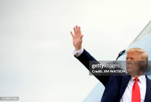 President Donald Trump waves from Air Force One as he departs Joint base Andrews in Maryland, for South Carolina, on October 25, 2019.