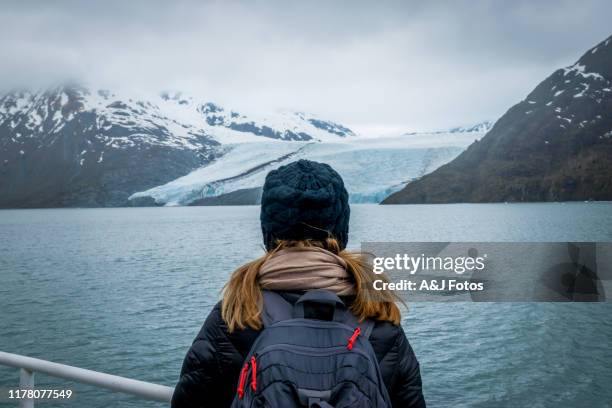 woman looking at mountain range and glacier. - alaska cruise stock pictures, royalty-free photos & images