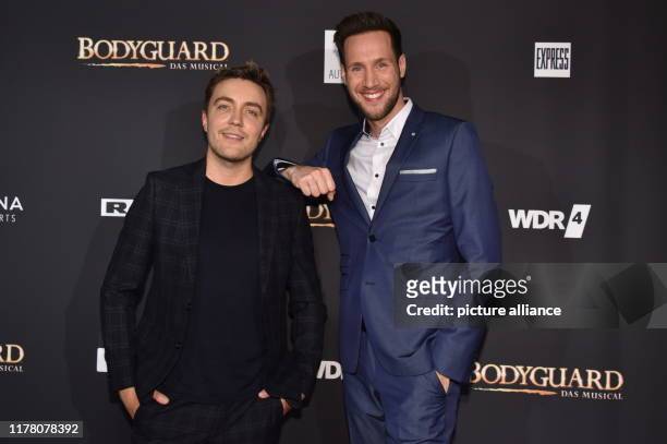 October 2019, North Rhine-Westphalia, Cologne: Moderators Philipp Isterewicz , l-r, and Sven Kroll come to the premiere and tour start of the musical...