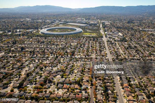 Houses stand near the Apple Inc. Campus in this aerial photograph taken above Cupertino, California, U.S., on Wednesday, Oct. 23, 2019. Apple Inc....