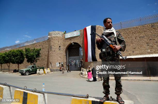 Houthi soldier stands guard outside the central prison during the release of 350 prisoner of the government forces arrested in the ongoing war, on...