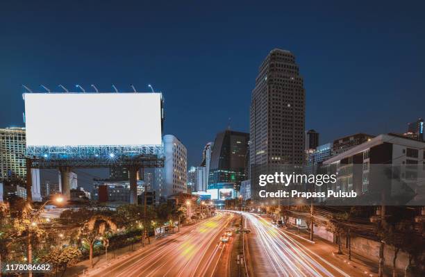 billboard street on light trails for outdoor advertising poster or blank billboard at night time for advertisement. street light - billboard 2017 stock-fotos und bilder